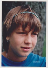 Lovely Short-Haired Girl with a Headband Glancing Playfully Away from the Camera