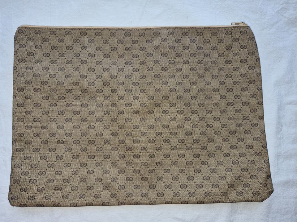 A sleek vintage Gucci GG monogram portfolio case that bridges 1970s Italian luxury with genuinely functional everyday carry.