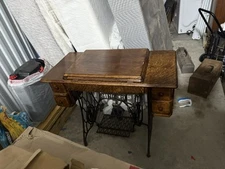 Antique Vintage Singer sewing machine in cabinet. Treadle Table Wrought Iron.