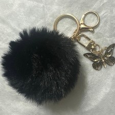Black Pom Pom key chain or bag charm w/black gold butterfly Charm. Brand New