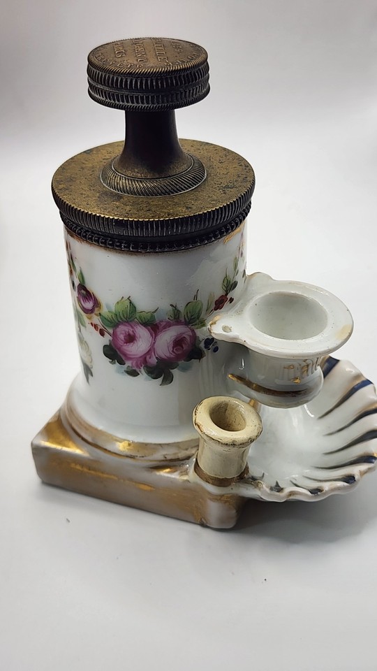 A hand-painted porcelain floral inkwell with a brass screw-top stand — an antique desk object so beautiful it's basically functional art.