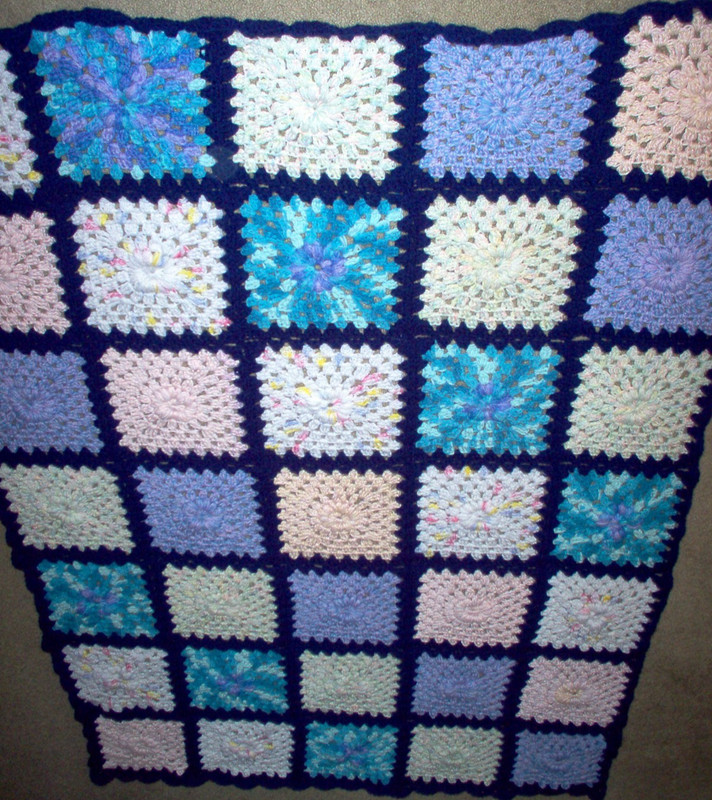 New crochet afghan,  42" x 62" multi color with navy boarder