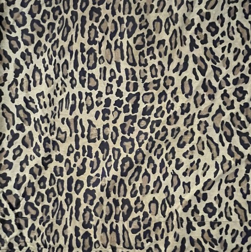 Tan fabric with dark brown and black leopard print pattern, white background, and visible seams.