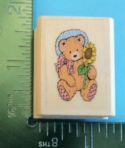 teddy bear holding a sunflower