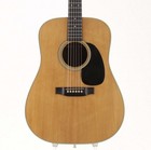 Light wood Martin D-28 acoustic guitar with black pickguard, silver hardware, and glossy rosewood fretboard.