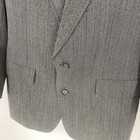 Grey vintage Christian Dior Monsieur suit jacket with notch lapels, two front flap pockets, and subtle textured fabric.