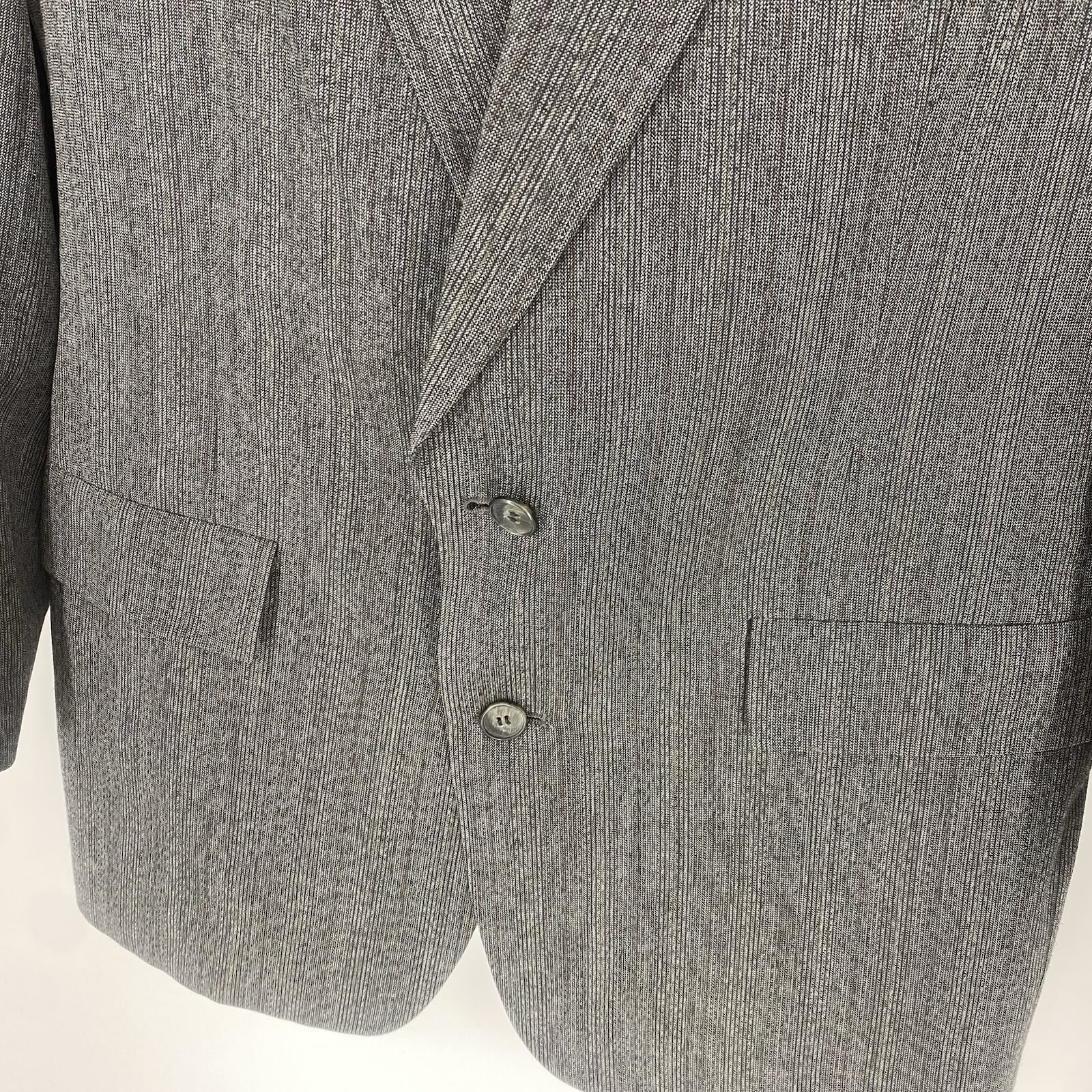 Grey vintage Christian Dior Monsieur suit jacket with notch lapels, two front flap pockets, and subtle textured fabric.