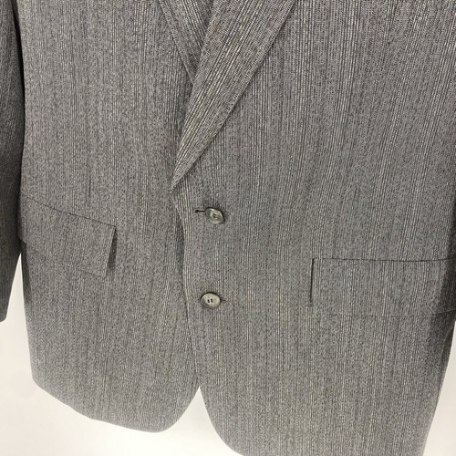 Grey vintage Christian Dior Monsieur suit jacket with notch lapels, two front flap pockets, and subtle textured fabric.