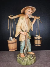 Japanese Man Carrying Water Buckets With a Yolk Figurine In Unglazed Porcelain