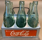 Vintage Coca-Cola Aluminum Carrier and 5 Vintage Bottles and 1 Reproduction