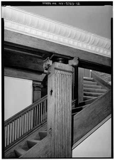 12. DETAIL OF CAST IRON COLUMN HEAD VISIBLE BEHIND CAPITAL OF WOODEN COLUMN