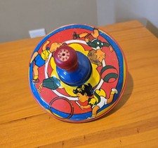 Vintage tin litho spinning top toy. Children Playing Running. Wooden push-down