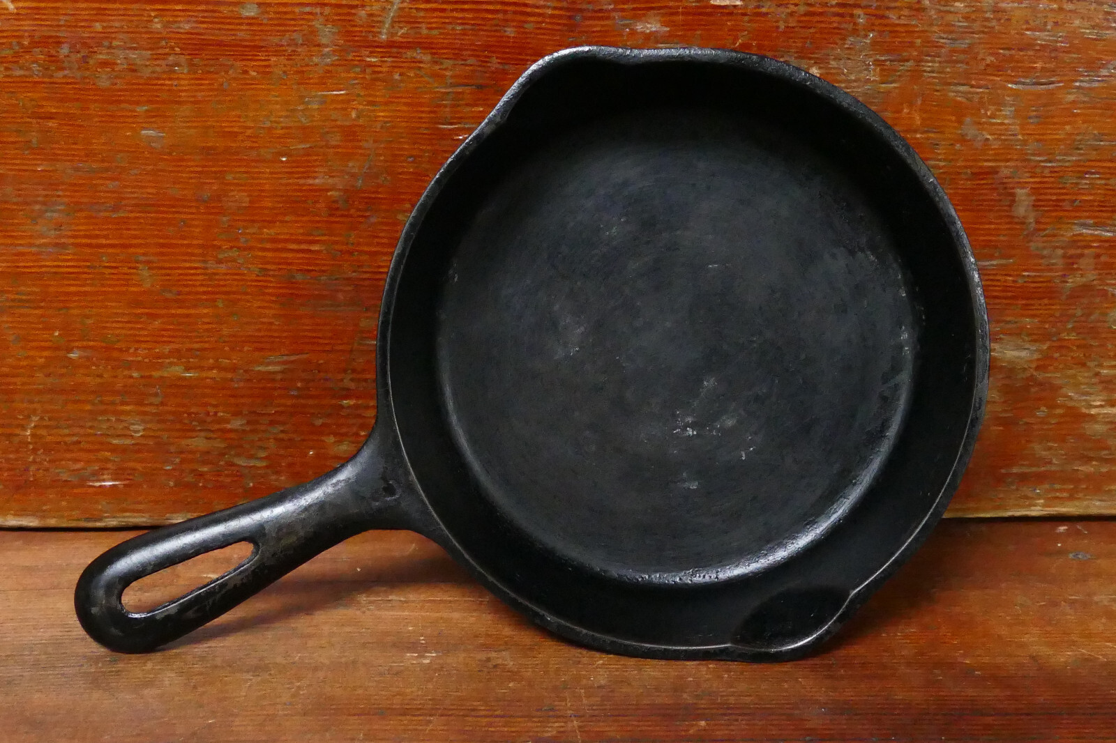 Small unmarked cast iron skillet, 6.5 inches, on a wood surface