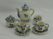 SEVEN-PIECE BLUE AND WHITE SPATTERWARE CHILD'S TEA SET ROCKING HORSE