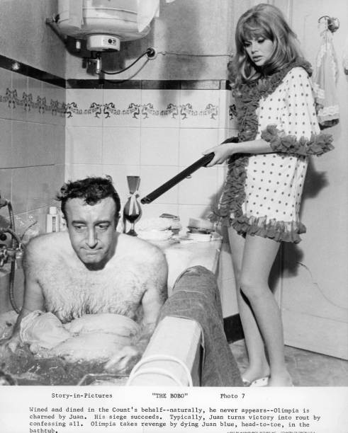 Peter Sellers in tub Britt Ekland holding gun in the film The Bobo- Old Photo