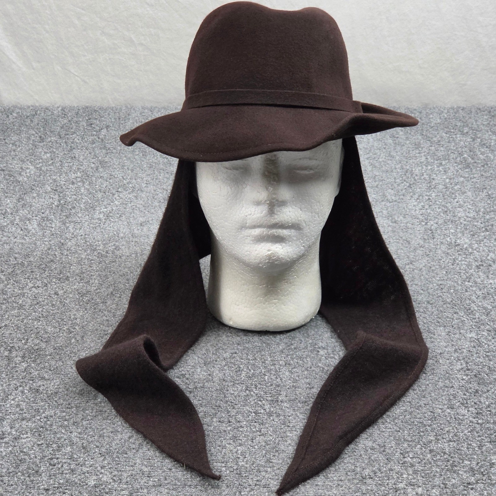 Brown wool felt wide-brim fedora hat with wrap scarf band, on a hat stand