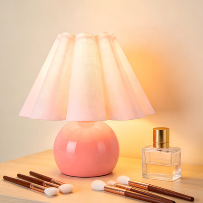 Pink table lamp with beige shade perfect for rustic industrial desks.