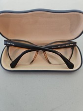 Miu Miu MU 03QV eyeglasses frame, featuring a glossy brown cat-eye Half Rim 50mm