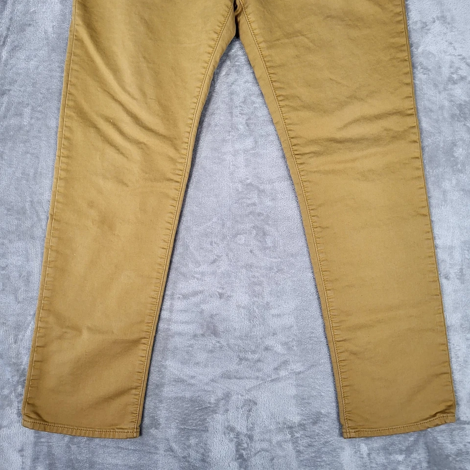 Pantalones de jean de viaje Banana Republic para hombre 34x32 (se adapta a 34x30) ajustados elásticos mostaza Foto 3 de 4