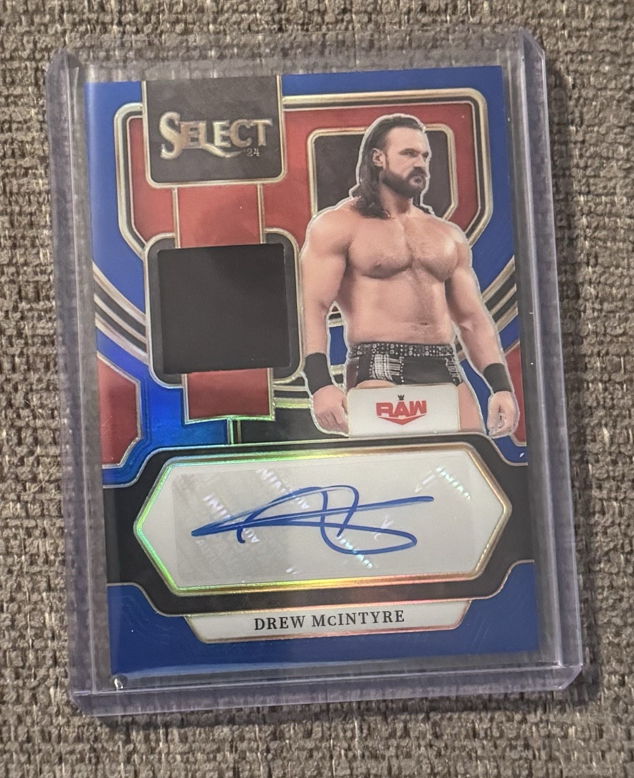 2024 Panini Select WWE - Autographed Memorabilia Drew McIntyre #AM-DMI Blue Prizm /35 (AU, MEM)