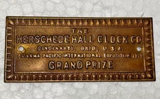 ANTIQUE VINTAGE HERSCHEDE GRAND PRIZE WALL SHELF CLOCK METAL PLATE LOGO TAG