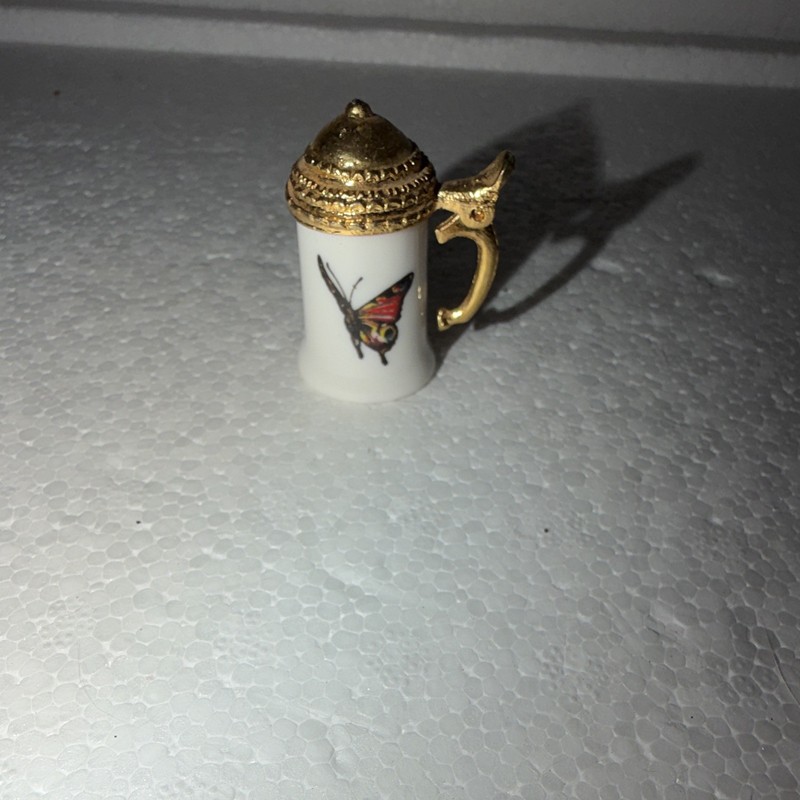 Collectible Symbol With Hand, Painted Butterfly, And Moving Handle
