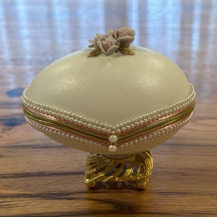 A hand-decorated real goose egg turned into a music box — a genuinely one-of-a-kind folk art object.