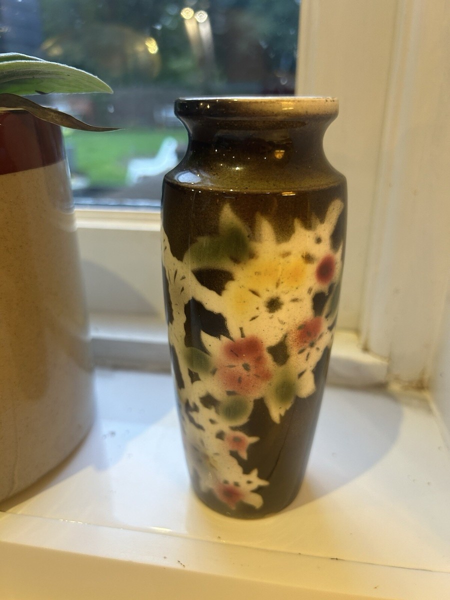 Premium Photo | Black vase with flowers on a dark background