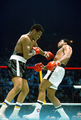 Mohammad Ali right dodges a punch by Jimmy Young left at the WBC - 1976 Photo 5