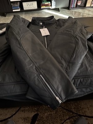 This is a Jordan x Travis Scott Waxed Jacket in black.