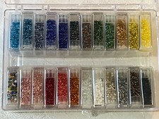 BEAD LANDING. 24 ASSORTED COLORS OF GLASS BEADS.