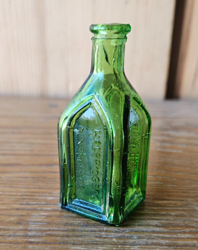 CHIEF WAHOO, ELECTRIC TONIC. WALBRIDGE CATHEDRAL BRAND. GREEN MINI TONIC BOTTLE