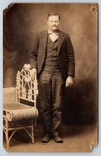 VINTAGE REAL PHOTO POSTCARD OLD PHOTOGRAPH MAN SUIT COAT TIE WICKER CHAIR RPPC