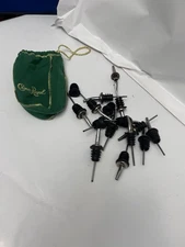 Bag of liquor bottle pours/tops in crown royal bag green