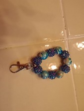 a beautiful handmade beaded clip made for keychains purses and other accessories