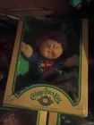 83 Cabbage Patch Fuzzy haired kid.  has build a bear outfit on with sketchers on