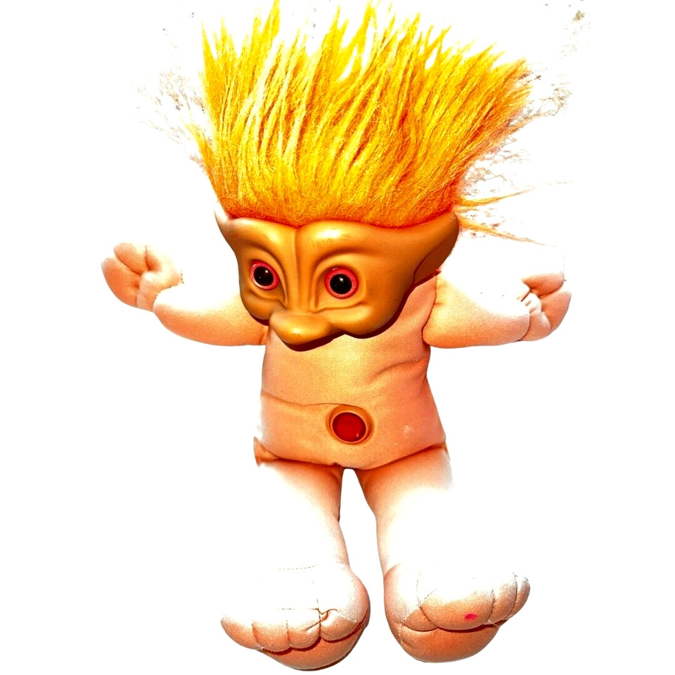 A detached vintage troll doll face mask with yellow hair — unsettling, surreal, and deeply charming in the way only genuine retro toy oddities can be.