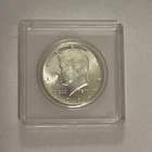 1964 Kennedy Half Dollar 90% Silver Coin In Plastic Case. Very Nice Condition.