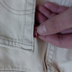 Cream off white VTG 1998 Levi’s 501 women’s jeans with red Levi’s tag on waistband, made in USA.