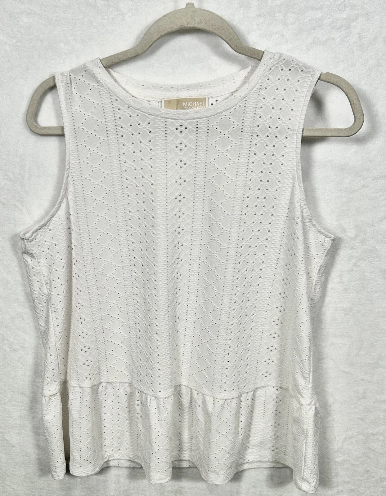 Top Michael Kors bianco con occhielli in pizzo senza maniche scollo tondo con volant grande L