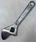 Silver 6" adjustable crescent wrench with black handle, yellow “706 PROTO” text, and chrome finish made in USA.