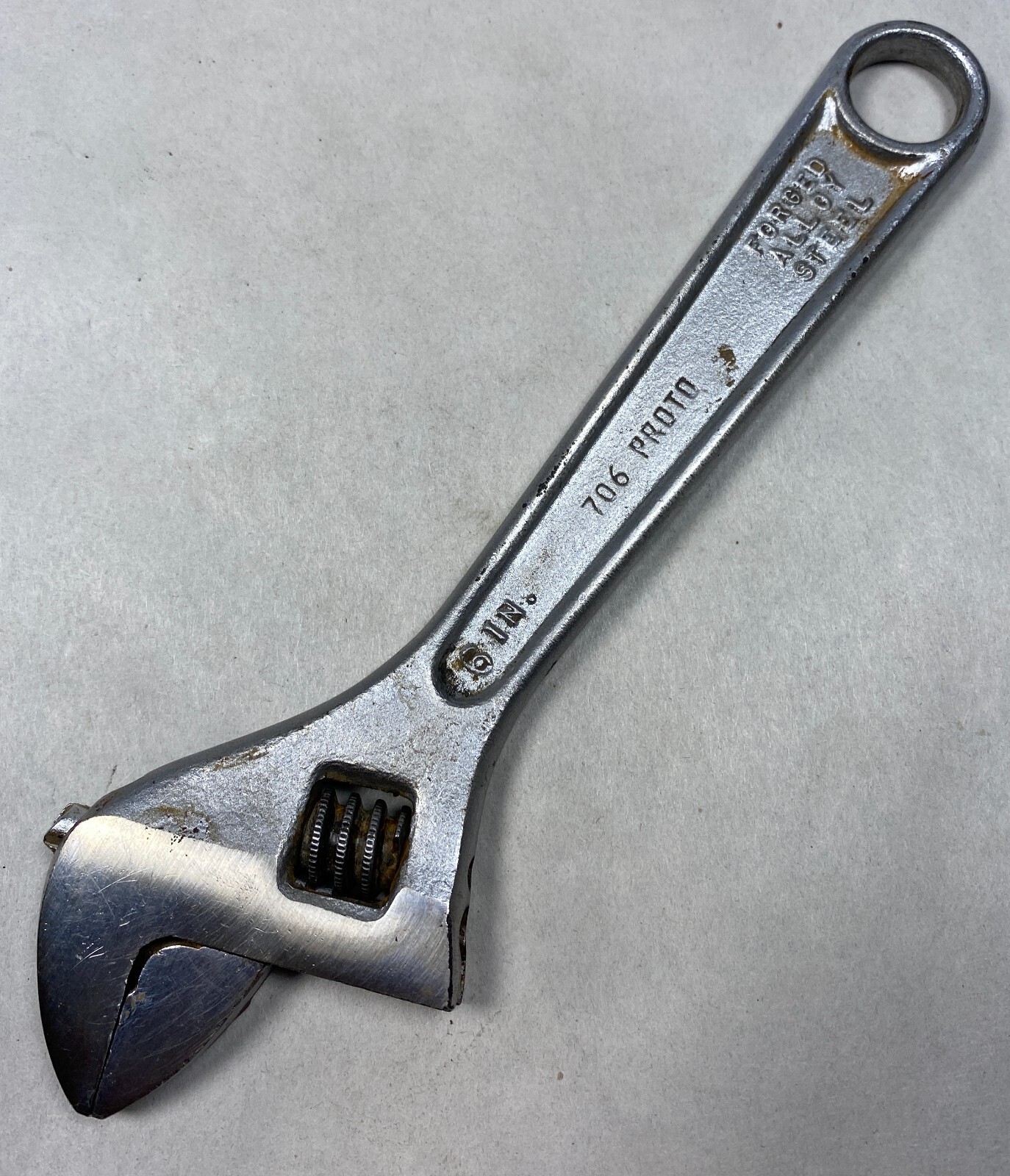 Silver 6" adjustable crescent wrench with black handle, yellow “706 PROTO” text, and chrome finish made in USA.