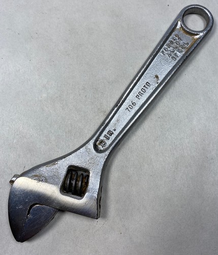Silver 6" adjustable crescent wrench with black handle, yellow “706 PROTO” text, and chrome finish made in USA.