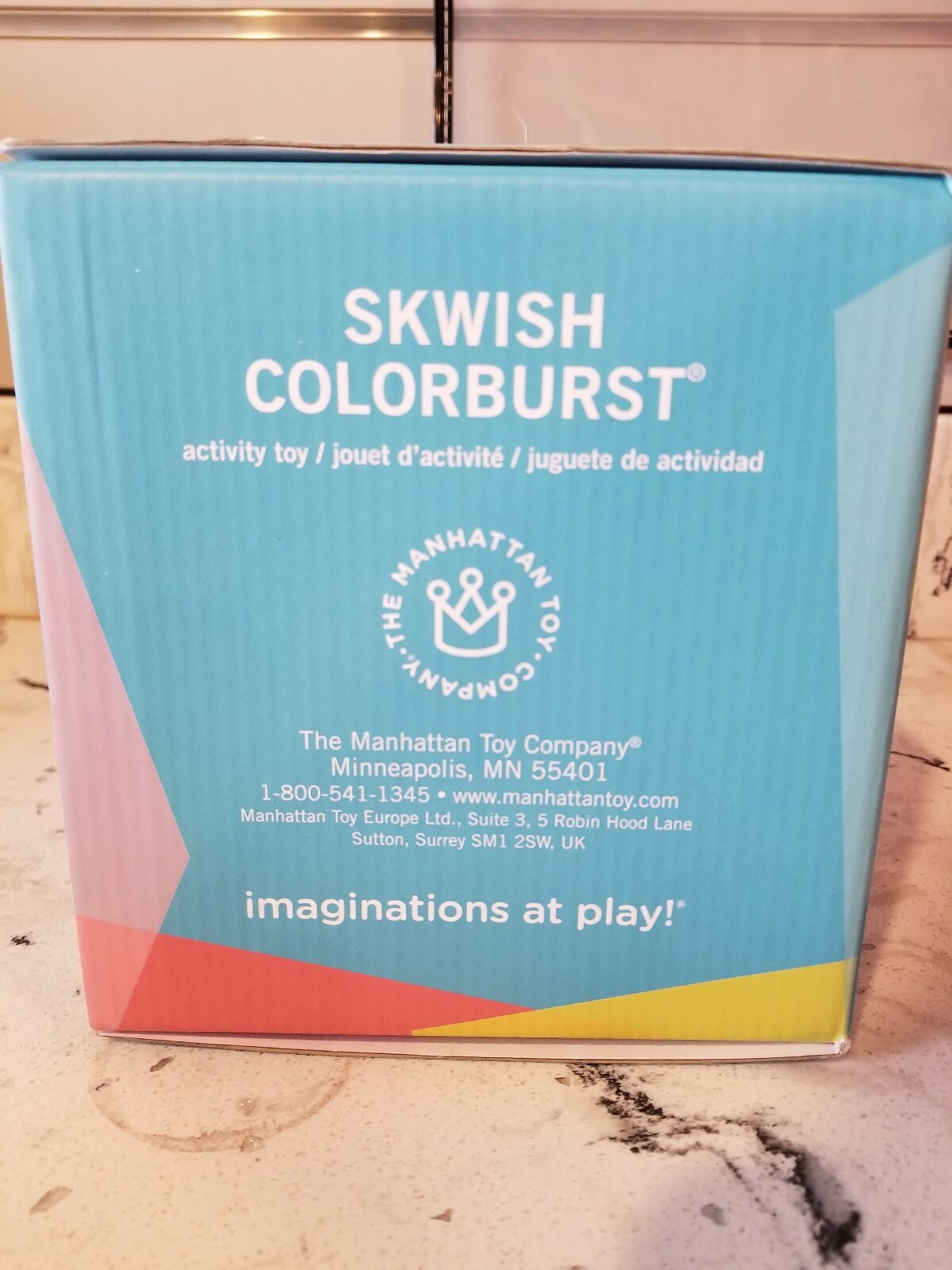 manhattan toy skwish color burst rattle and teether grasping activity toy