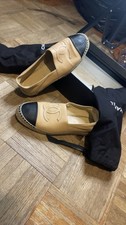 CHANEL espadrilles in beige leather with a black cap toe.