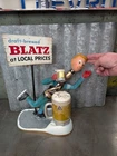 VINTAGE 1950s BLATZ Beer, Ice Skater Bottle Man  Metal W/ Sign. Needs Repair.