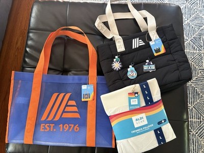 ALDI Gear 50th anniversary bundle. Two totes, a pullover, and 3 quarter holders.