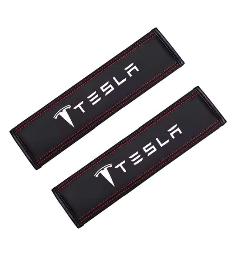 2x Car seat belt covers featuring the Tesla logo and word