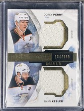 Perry, Corey/Kesler, Ryan - 2015-16 Upper Deck Premier - Dual Swatch - 104/149