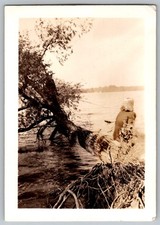 Vtg B&W Snapshot Woman Sitting On Fallen Tree Trunk Over Scenic Lake 1940s